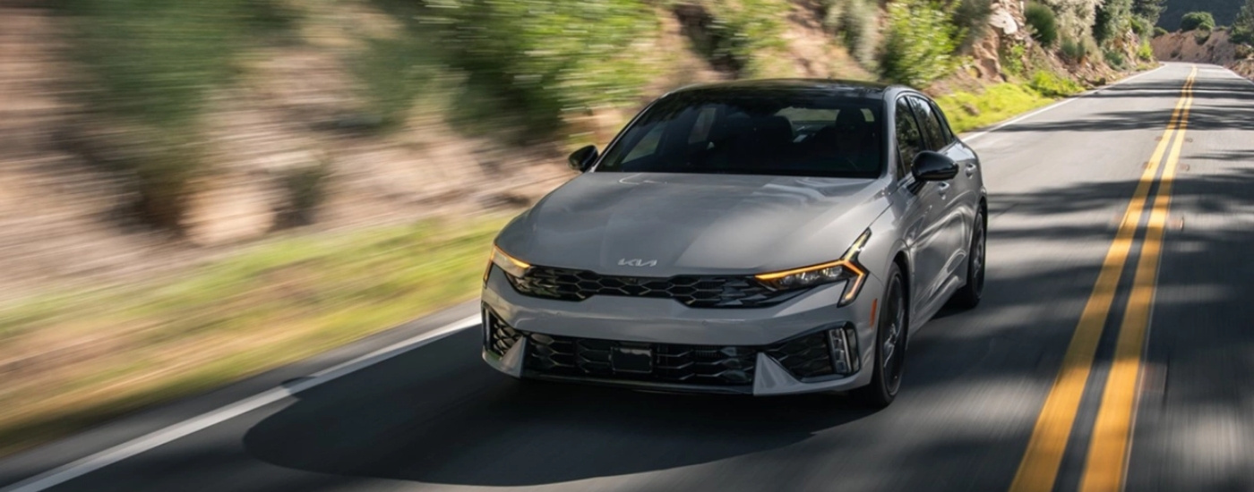Gray 2025 Kia K5 GT driving on a highway