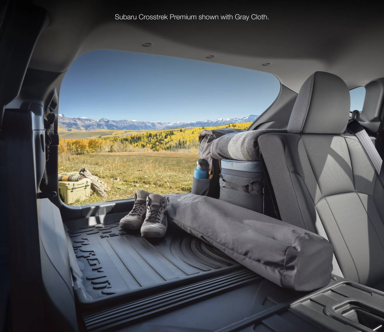 Interior view from the open trunk of a Subaru Crosstrek Premium with Gray Cloth seats, packed with outdoor gear.