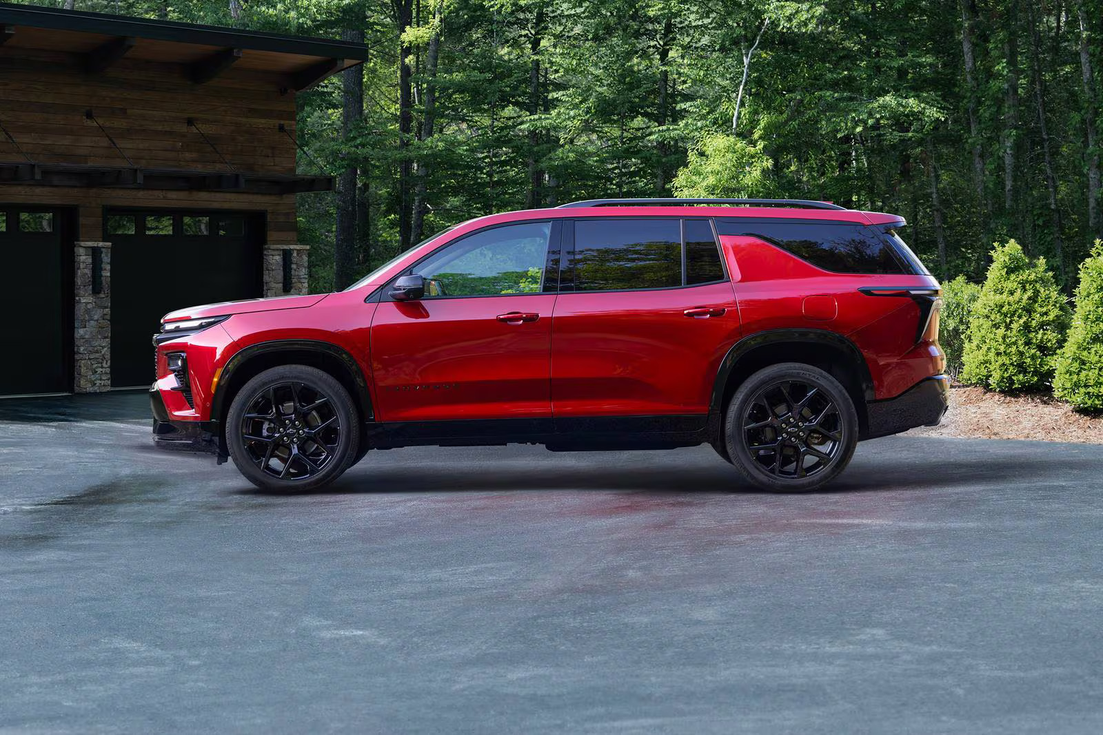 A red suv parked in a driveway.