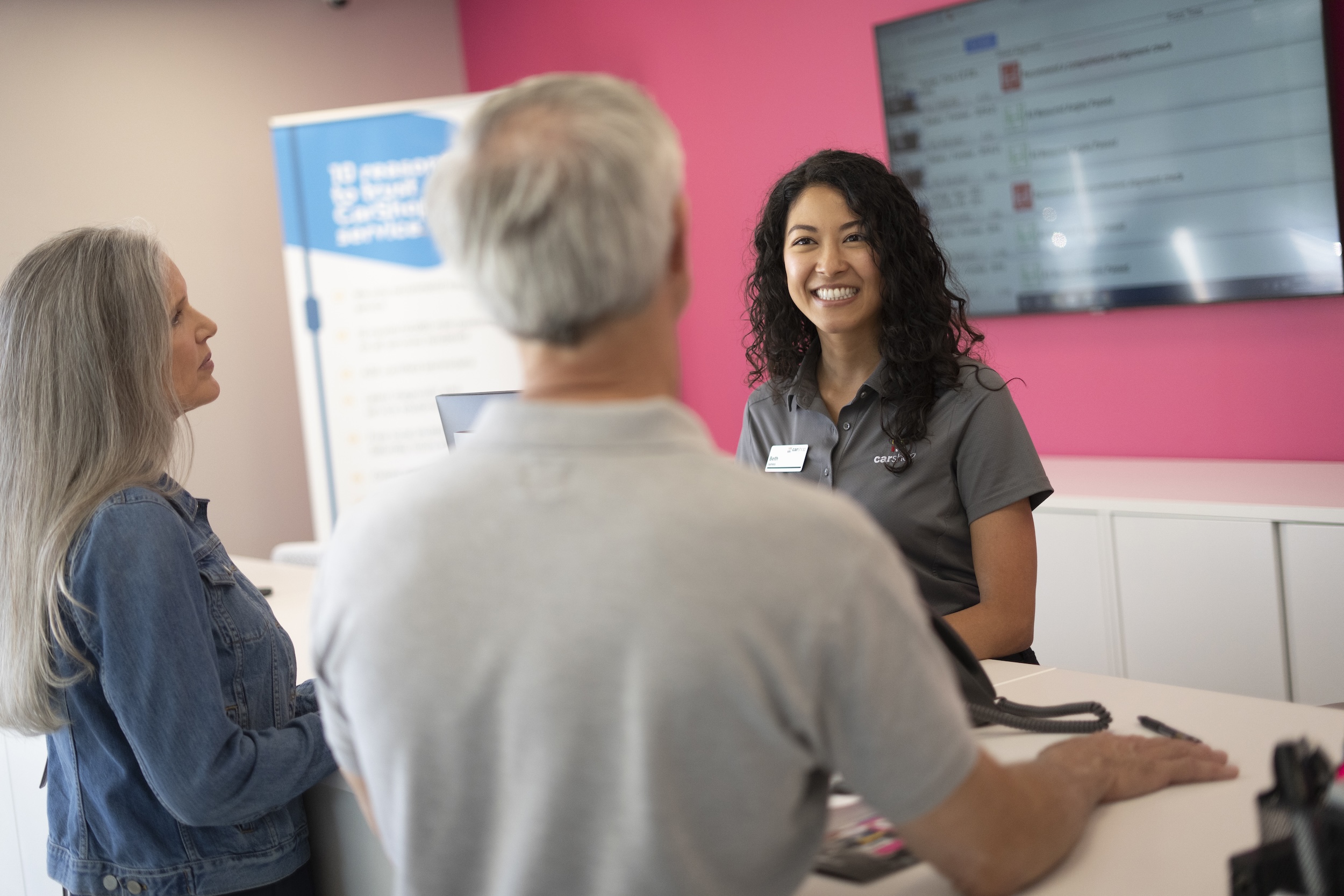 Associate smiling with two clients