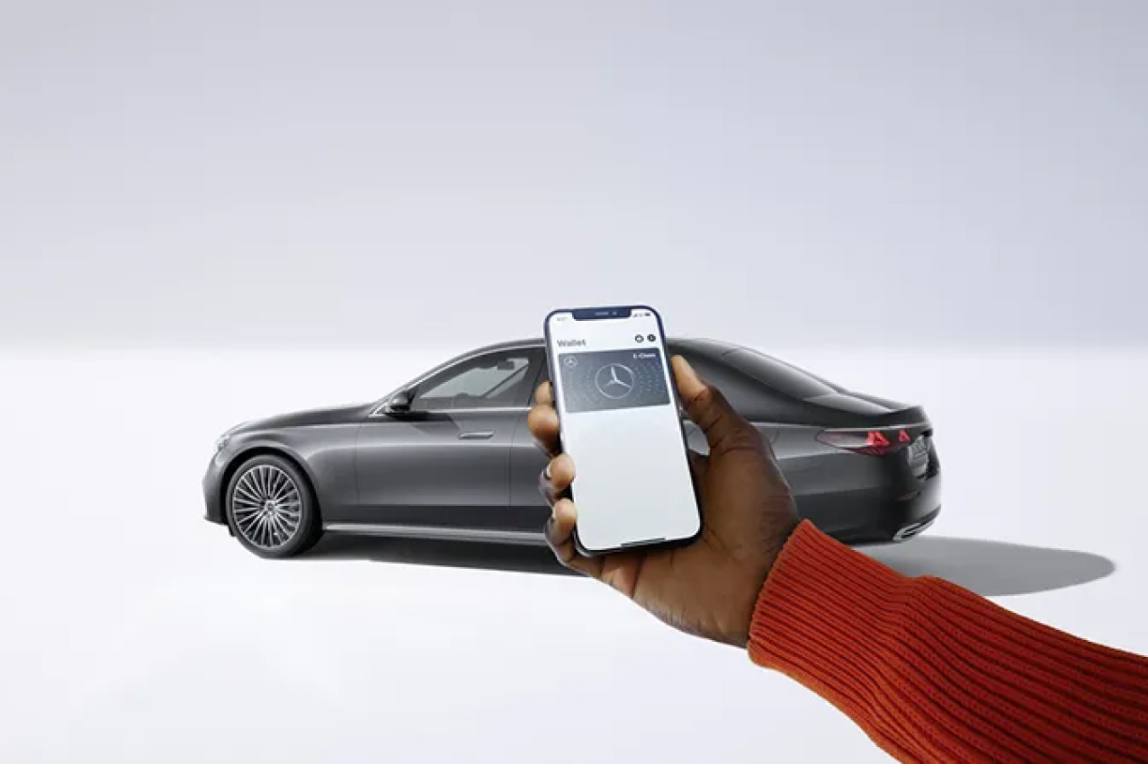 Smartphone held up in front of vehicle