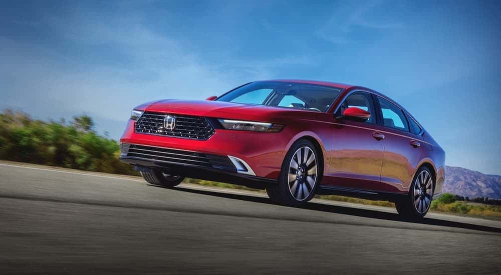 A red 2023 Honda Accord is shown from the front at an angle.