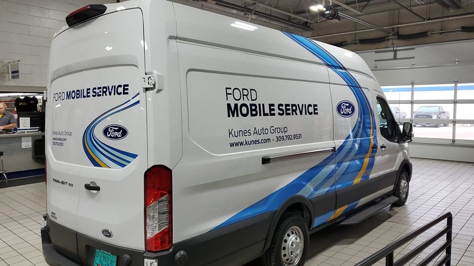 white worker van that says ford mobile service on the side. 