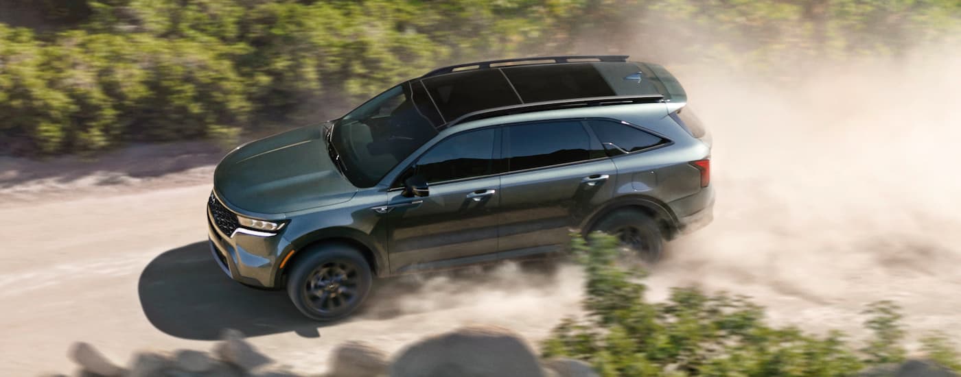 Green 2023 Kia Sorento for sale driving on a dirt road