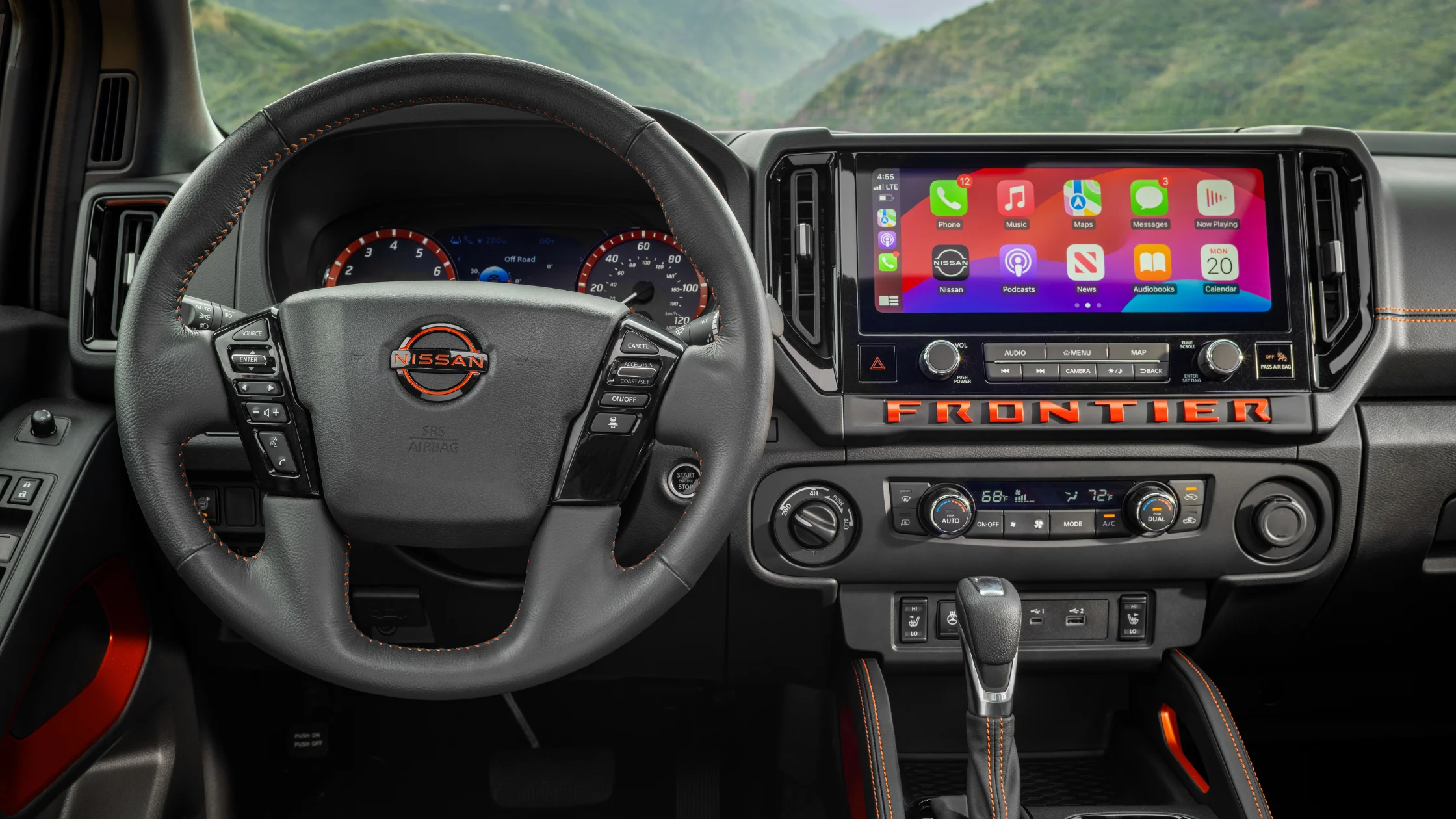 2026 Nissan Frontier® dashboard with Apple CarPlay, climate controls, and rugged trim