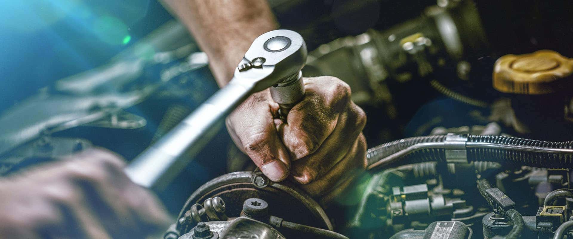 Auto mechanic working on car engine in mechanics garage. Repair
