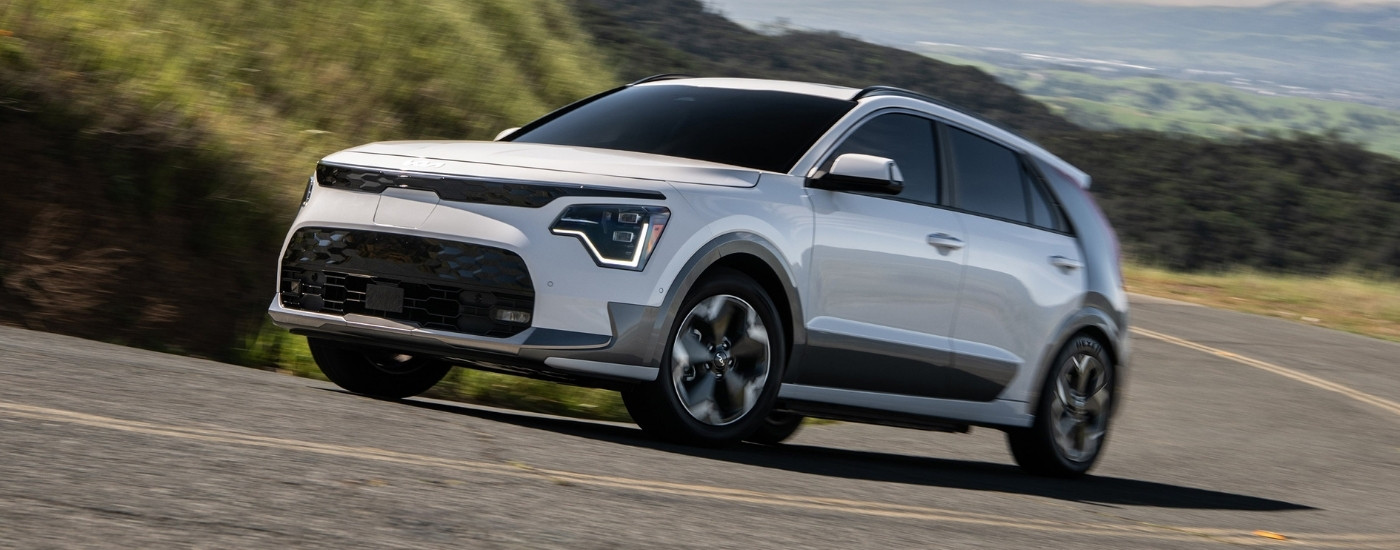 White 2025 Kia Niro EV driving to a Kia dealer near West Allis