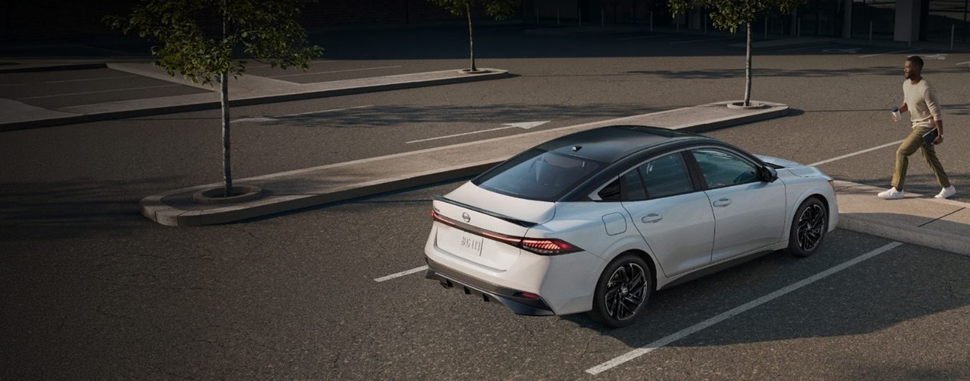 A white 2026 Nissan Sentra stopped at a crosswalk