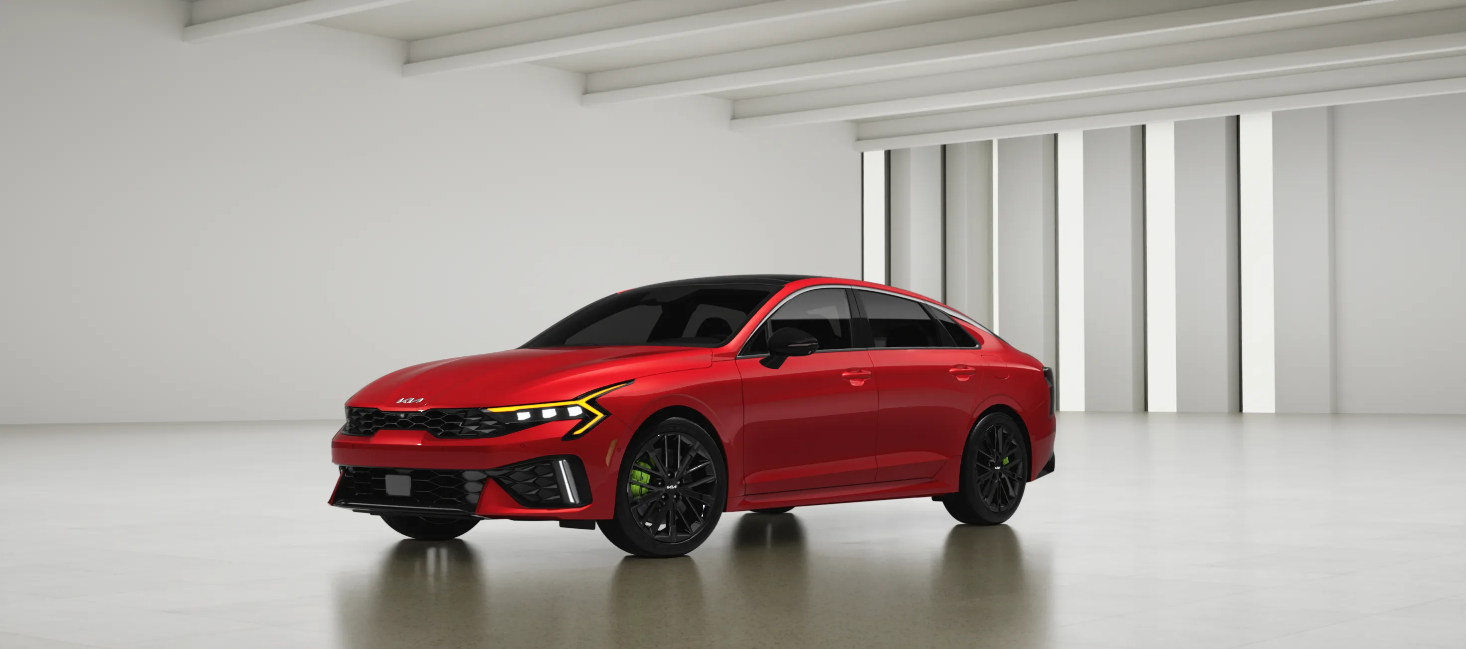 Red Kia K5 sedan with black wheels and green brake calipers in a white studio