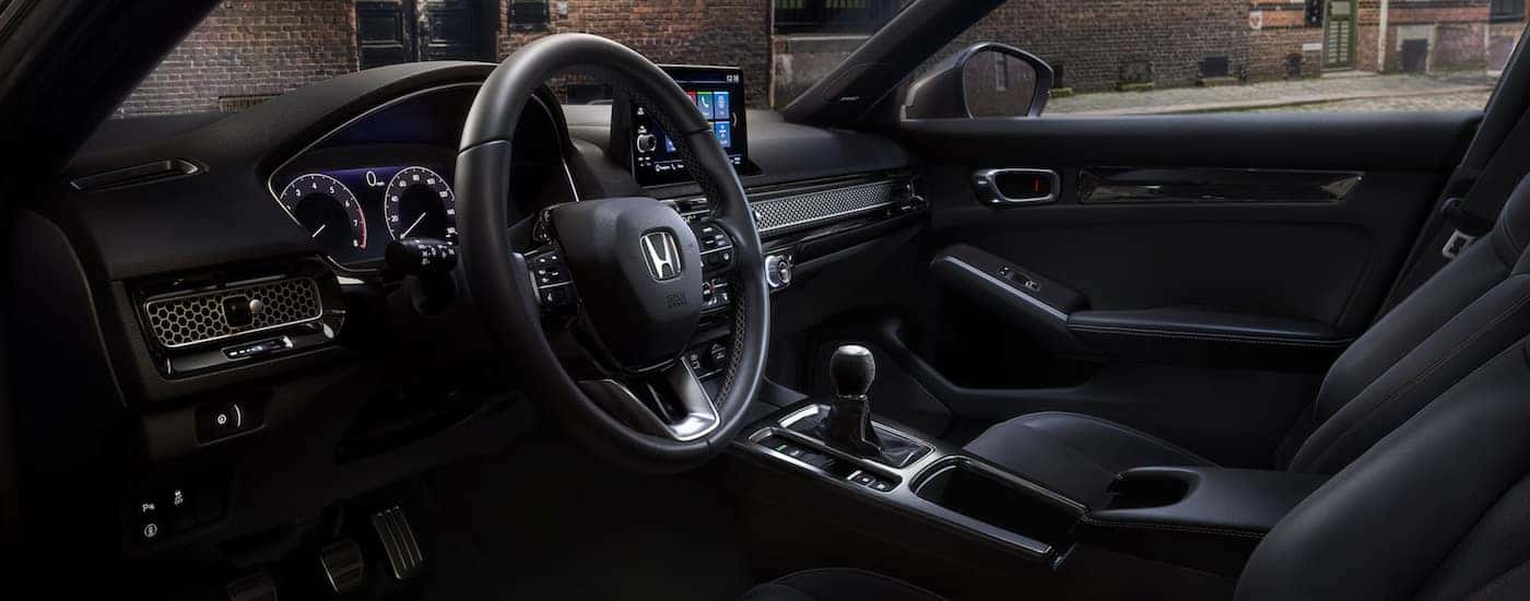 The cockpit of a 2024 Honda Civic Hatchback Sport Touring for sale.