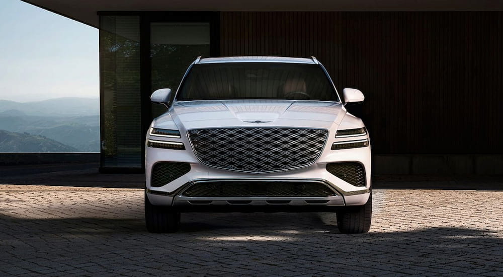 White 2026 Genesis GV80 parked on a driveway.
