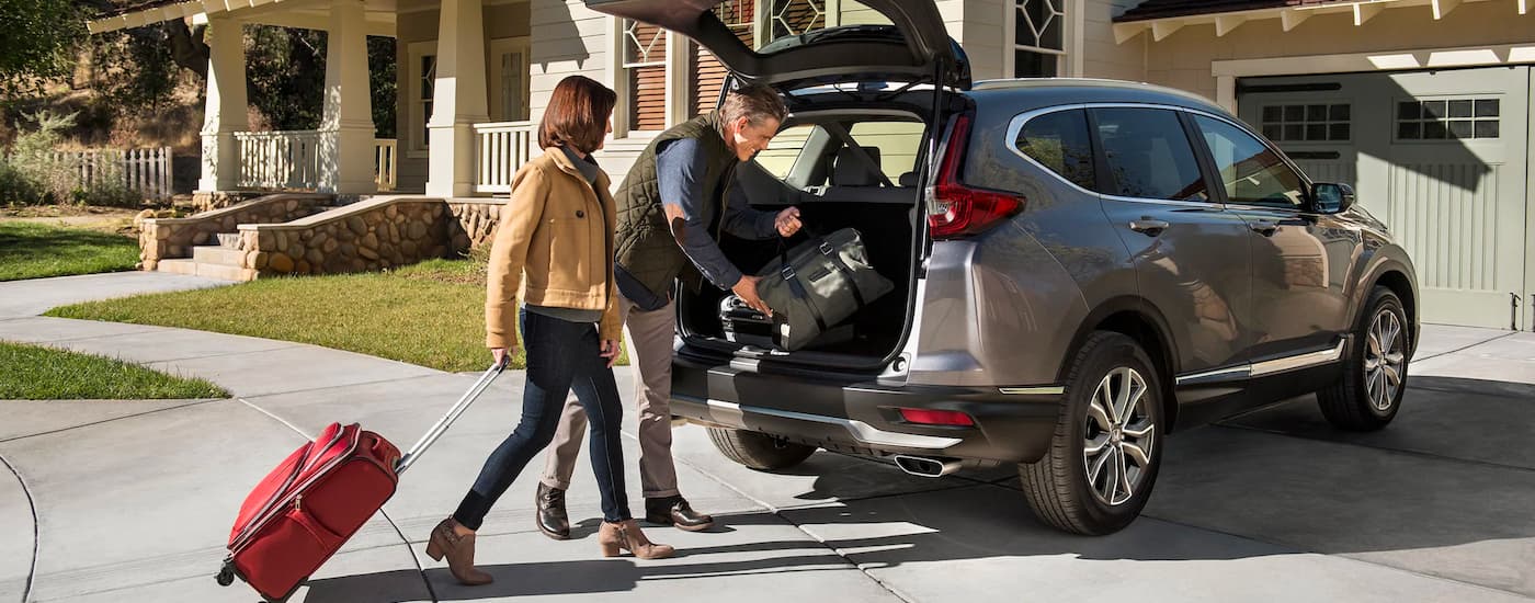 Couple loading cargo into the rear of a 2020 Honda CR-V Touring