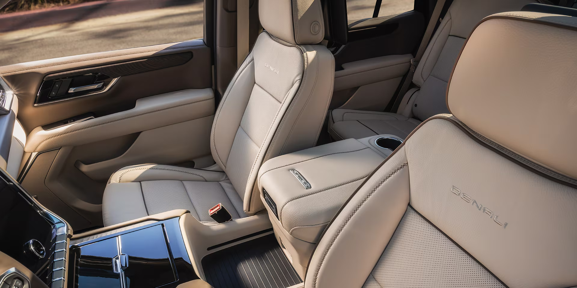GMC Yukon Denali interior with light leather front seats and second-row captain’s chairs