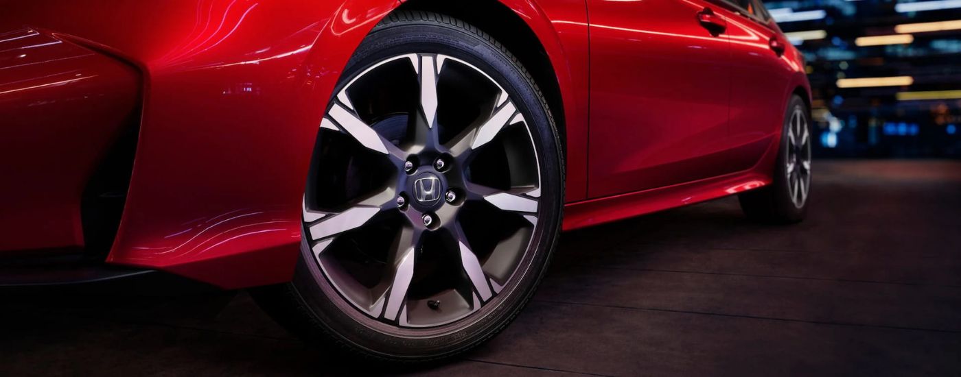 A close up shows the driver side wheels and tires on a 2025 Honda Civic Hybrid Sport Touring.