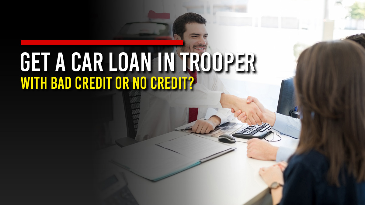 Smiling car dealership finance manager shaking hands with a customer couple across a desk with loan paperwork, next to the headline “Get a Car Loan in Trooper with Bad Credit or No Credit?”