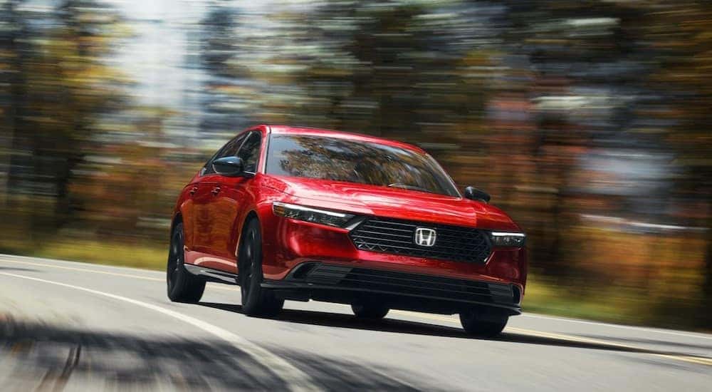 A red 2024 Honda Accord EX is shown driving to view a Honda Accord for sale in Rochester.