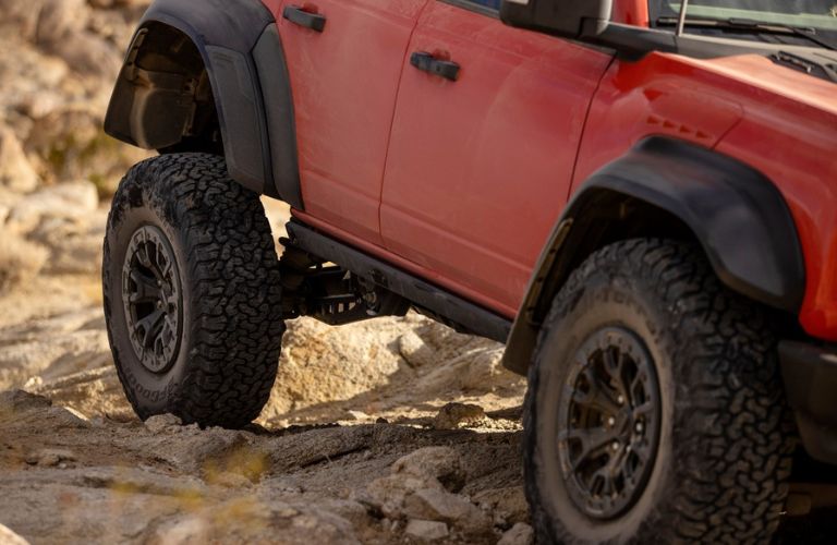 Close Up of 2023 Ford Bronco Raptor Suspension on Rocky Trail