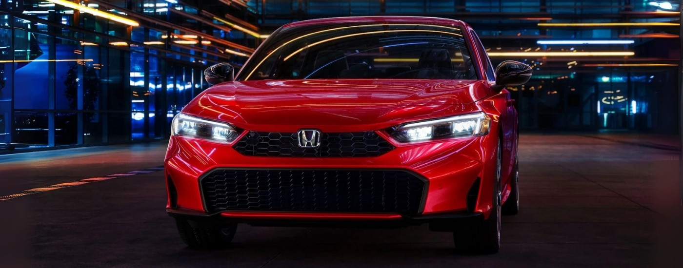 Red 2025 Honda Civic parked in a city at night