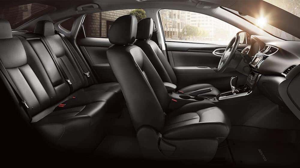 2018 Nissan Sentra black leather front and rear seats seen through the driver door