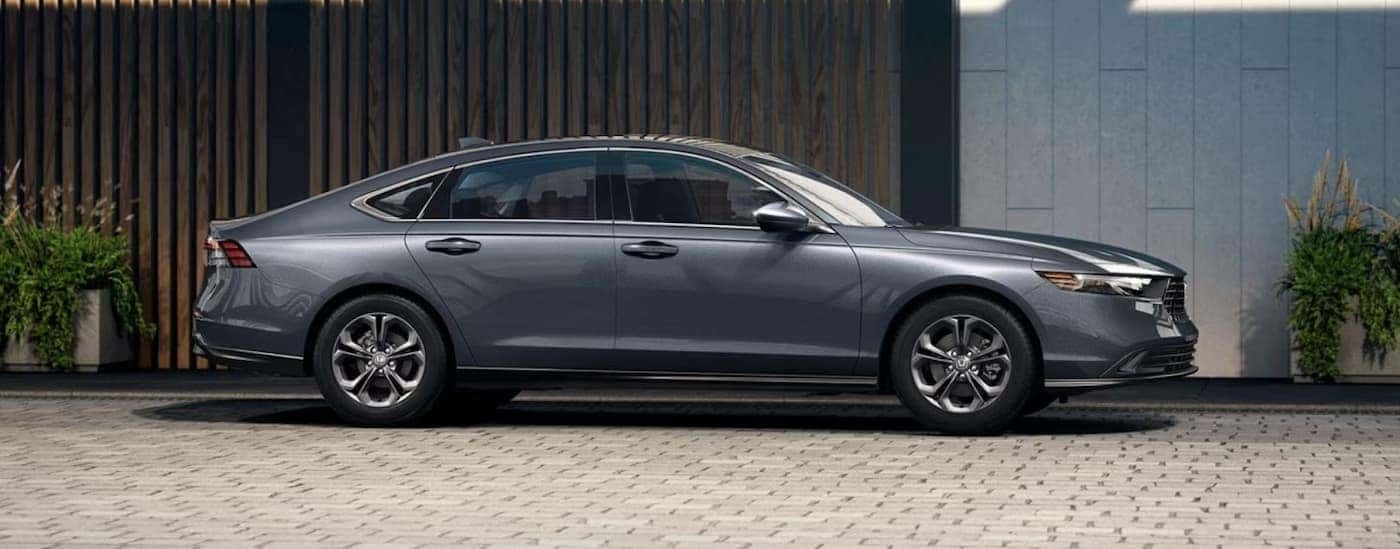 A gray 2024 Honda Accord is shown parked near a building.