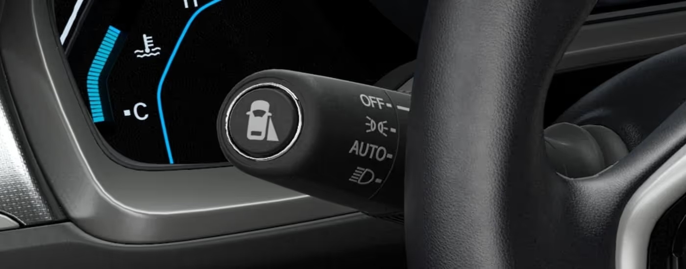 Lane keep assist icon on the black headlight stalk in a 2021 Honda Civic EX