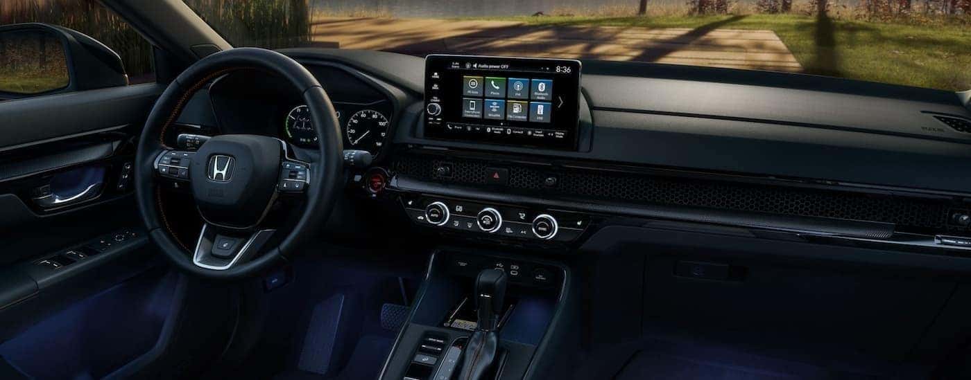 The black interior and dash are shown in a 2025 Honda CR-V Sport Touring.