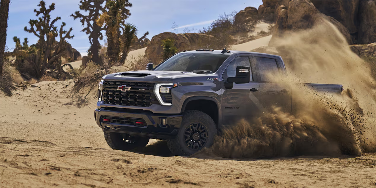 The 2024 Chevrolet Silverado 2500 HD driving in dirt.