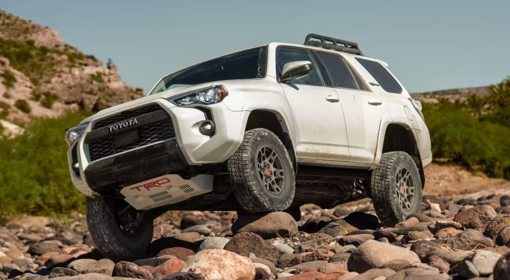 White Toyota 4Runner TRD Pro climbing over rocks