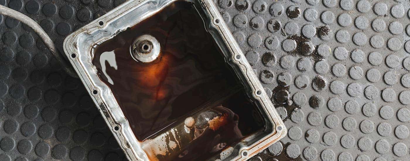 A close up of a fluid pan on the ground.