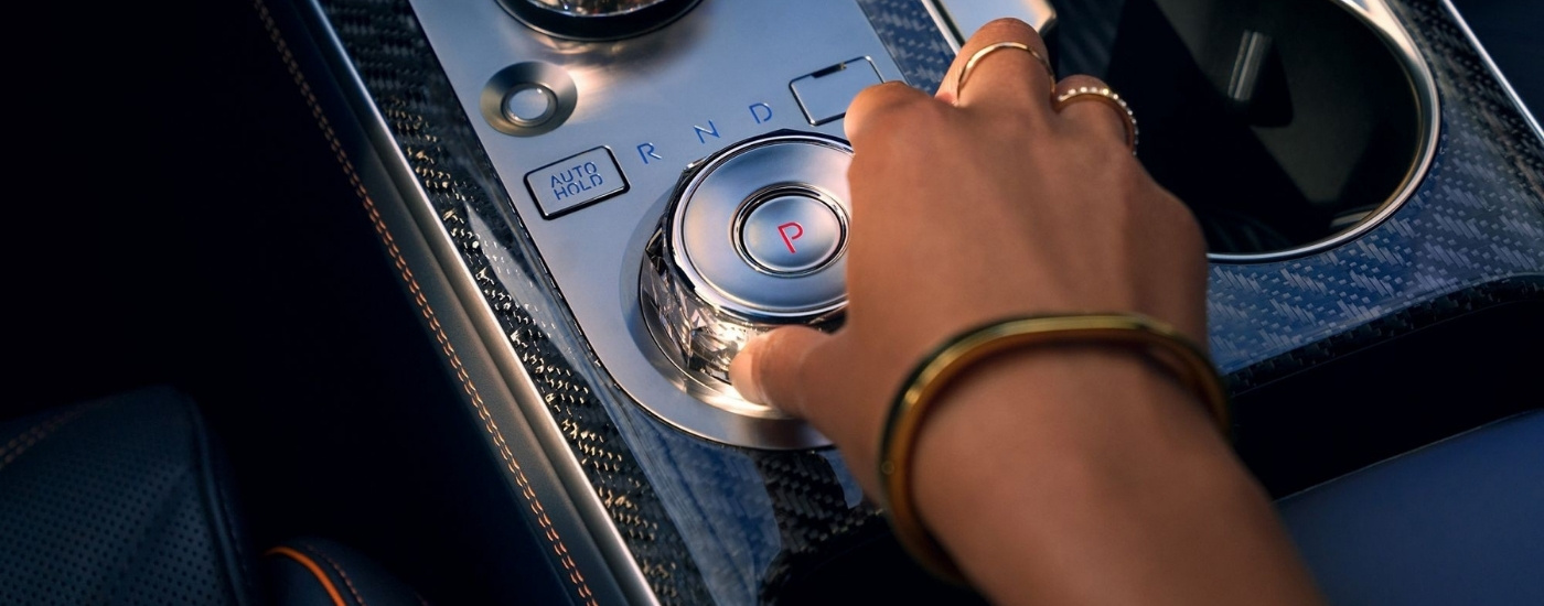 Person using gear selector dial in a 2026 Genesis GV70