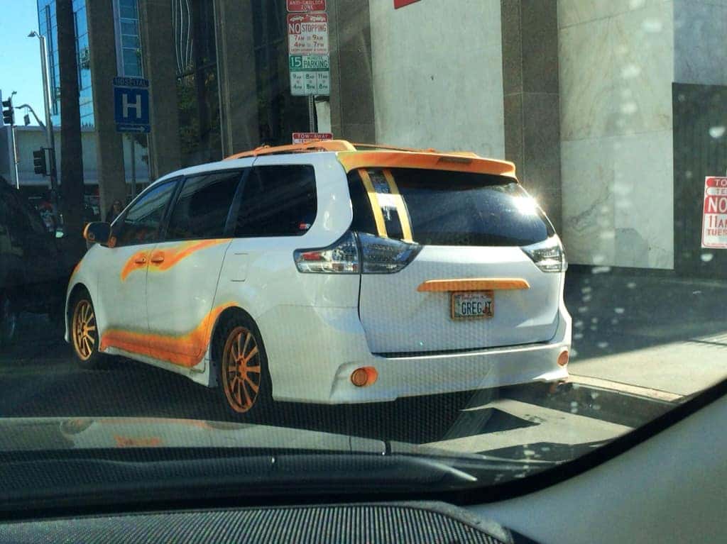 White minivan with a custom orange wrap