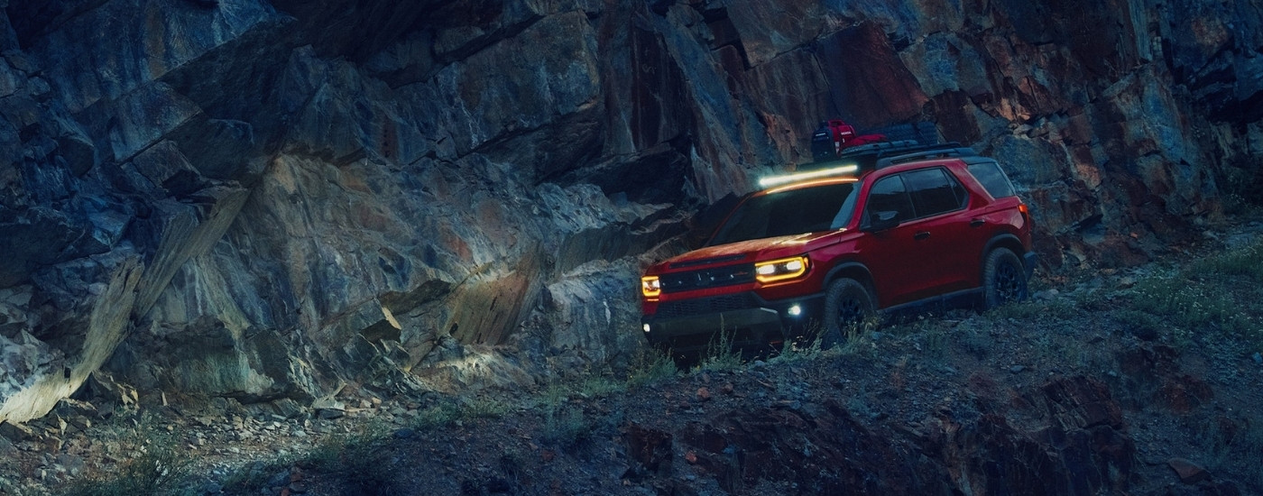 Red 2026 Honda Passport TrailSport Elite off-roading