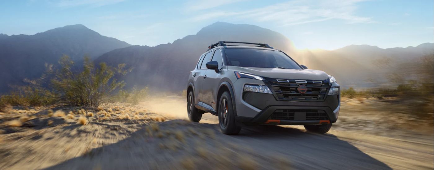 A gray 2026.5 Nissan Rogue Rock Creek shown driving off-road.