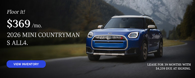 Front view of a blue MINI Countryman  driving on a mountainous road.