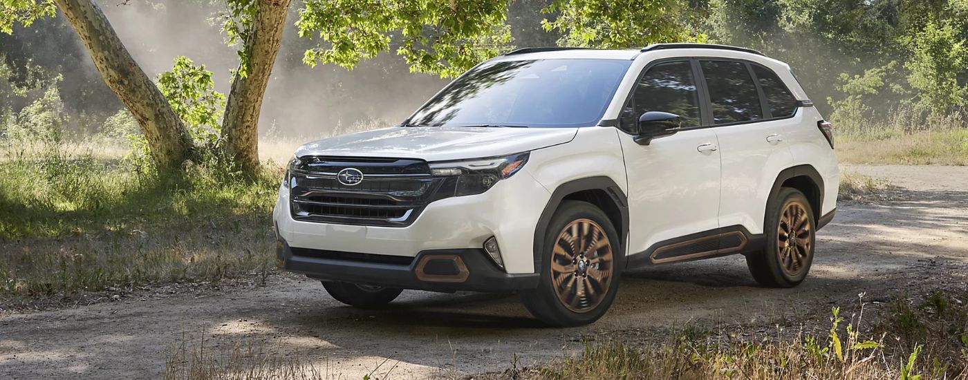 A white 2026 Subaru Forester Sport driving off-road.