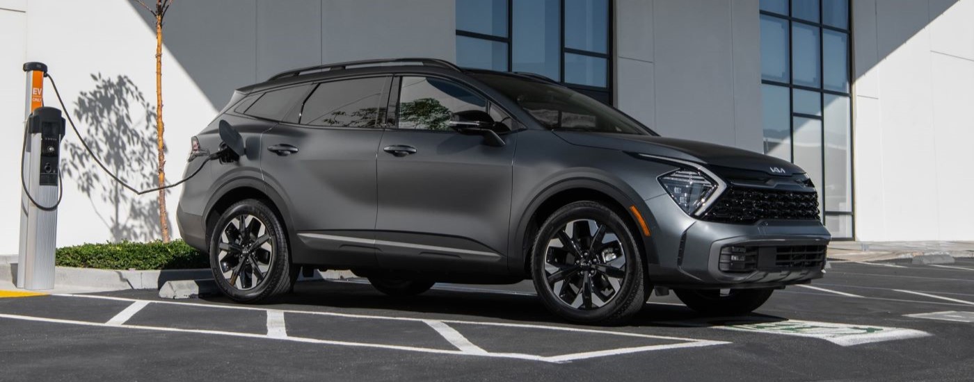 Grey 2023 Kia Sportage PHEV parked in a parking lot.