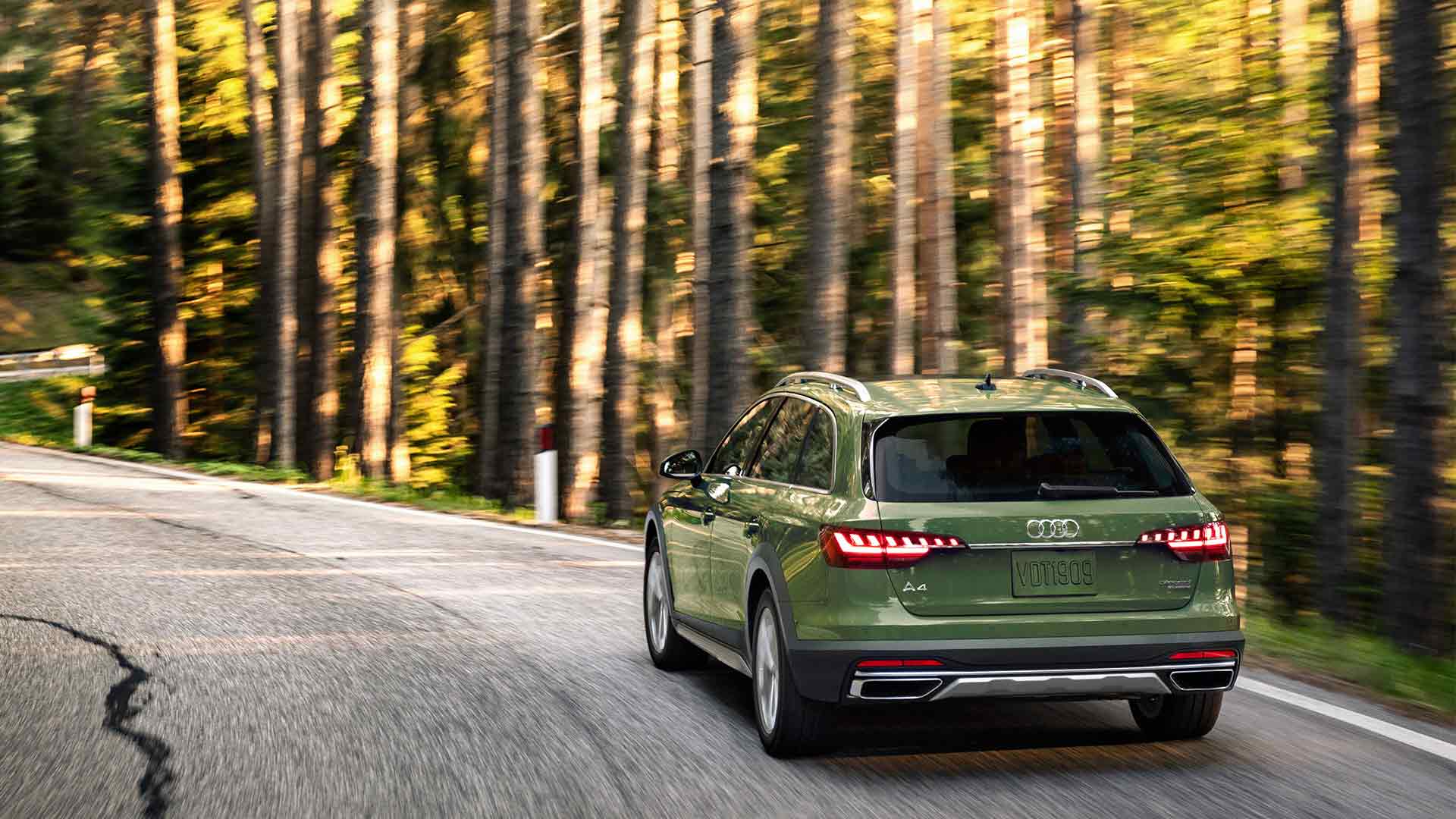 Three-quarter back view of an Audi A4 accelerating.