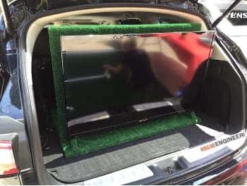 Flat-screen TV mounted in the open cargo area of a Subaru