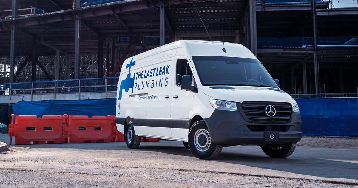 A Mercedes-Benz Sprinter cargo van used for commercial plumbing services.