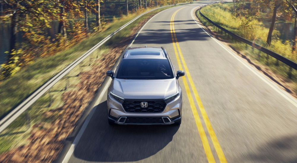 Silver 2026 Honda CR-V driving down an open road