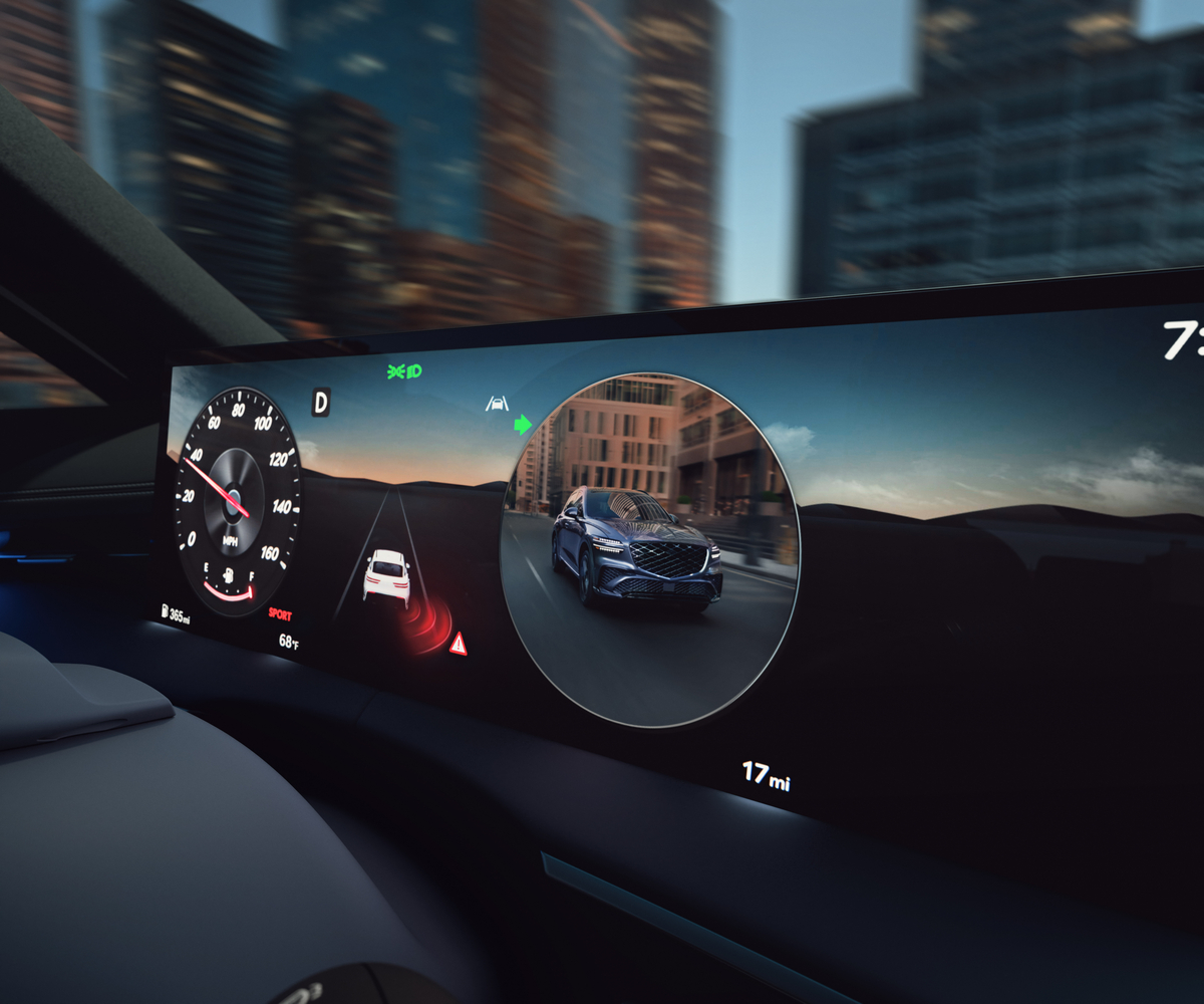 Closeup of instrument cluster details inside Genesis G80, motion blurred city in background