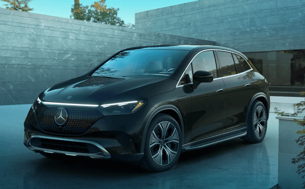 A black Mercedes-Benz AMG EQE SUV parked in a driveway.