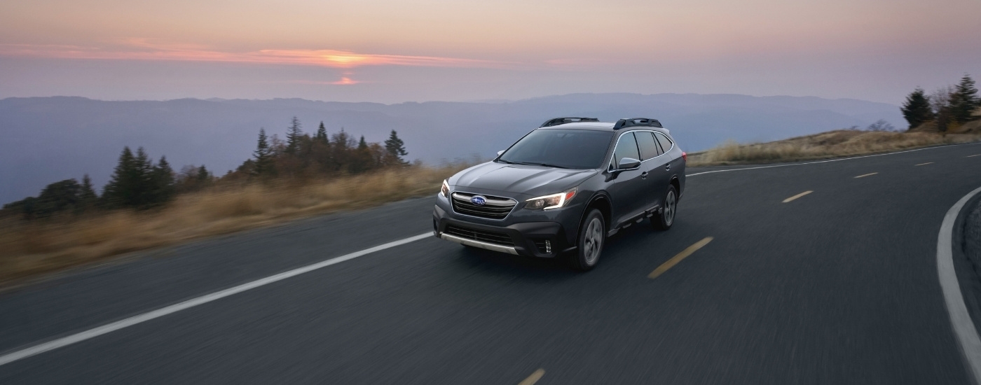 Grey 2020 Subaru Outback rounding a corner.
