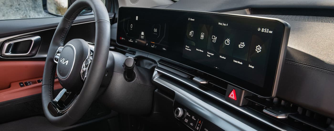 The wheel and dash of a 2026 Kia Carnival.
