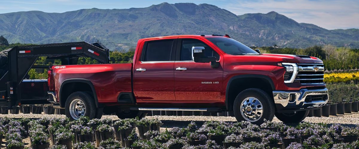 2025 Chevy Silverado 3500HD Dually Exterior Passenger Side Front Profile while 5th-Wheel Towing