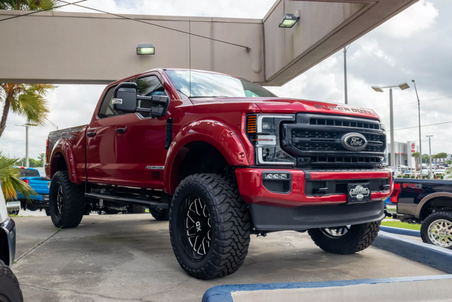 Red Ford Super Duty Parked in Front of Brandon Ford