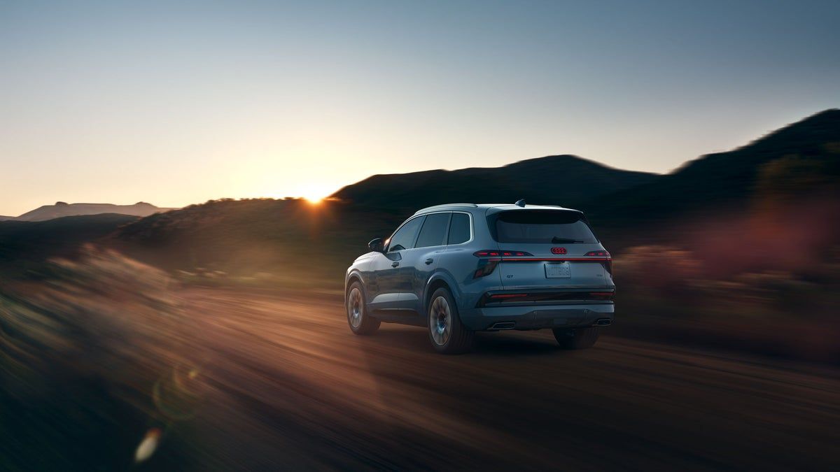 2027 Audi Q7 seen from behind on a sunset road