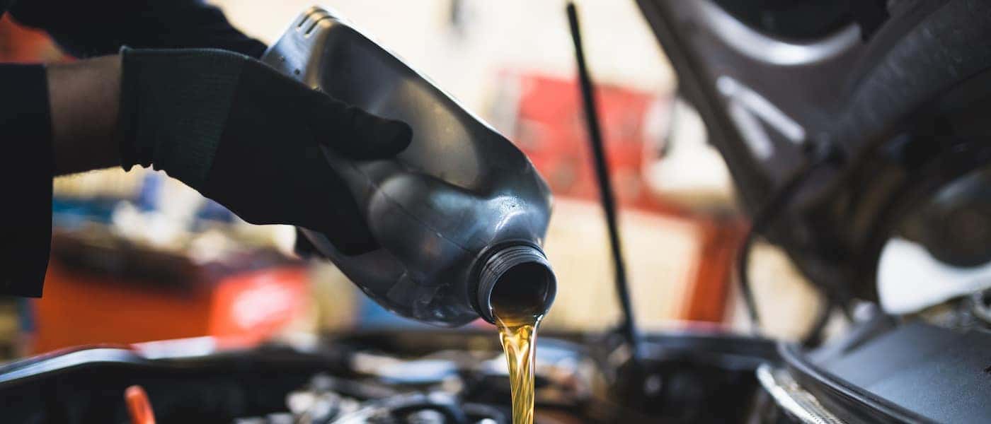 Pouring oil into a car engine