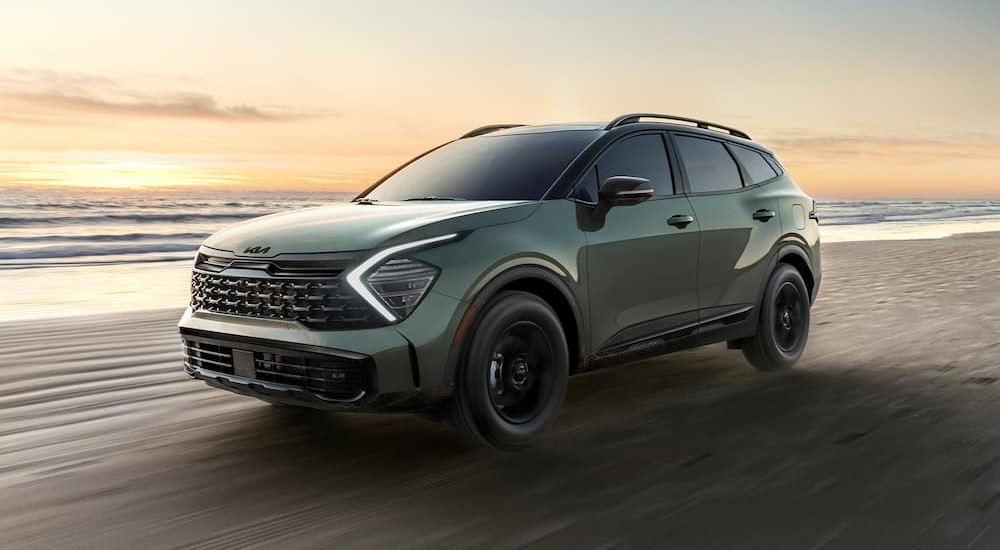 Green 2025 Kia Sportage X-Pro Prestige driving off-road