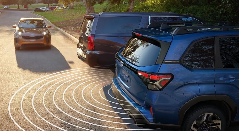 Simulated lines showing the Rear Cross Traffic Alert feature on a blue 2025 Subaru Forester for sale near Millbrook.